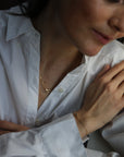 women wearing a matching necklace and bracelet set in 14 karat gold