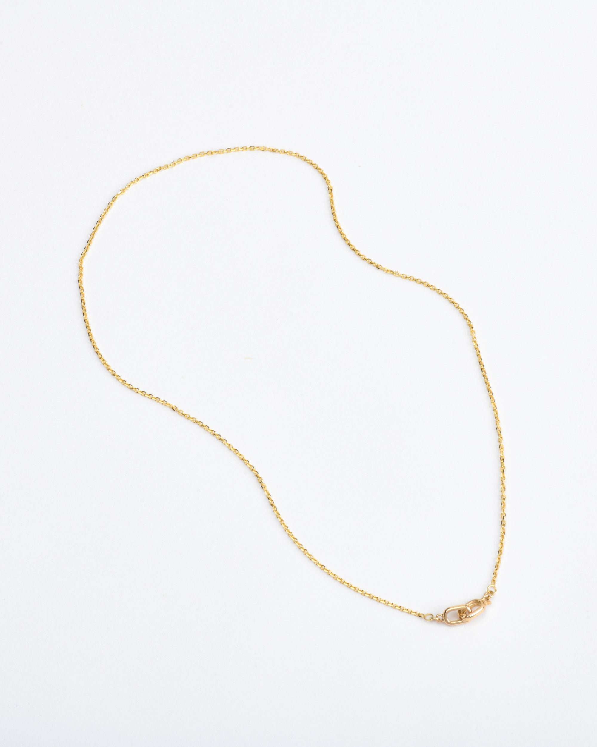 dainty 14k gold chain necklace on white background