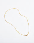 dainty 14k gold chain necklace on white background