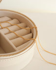 aesthetic round jewelry box with a 14 karat gold necklace made from wheat chain