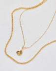 two 14 karat gold necklaces featuring a mini disc pendant with texture. An easy to wear necklace pair for classic style