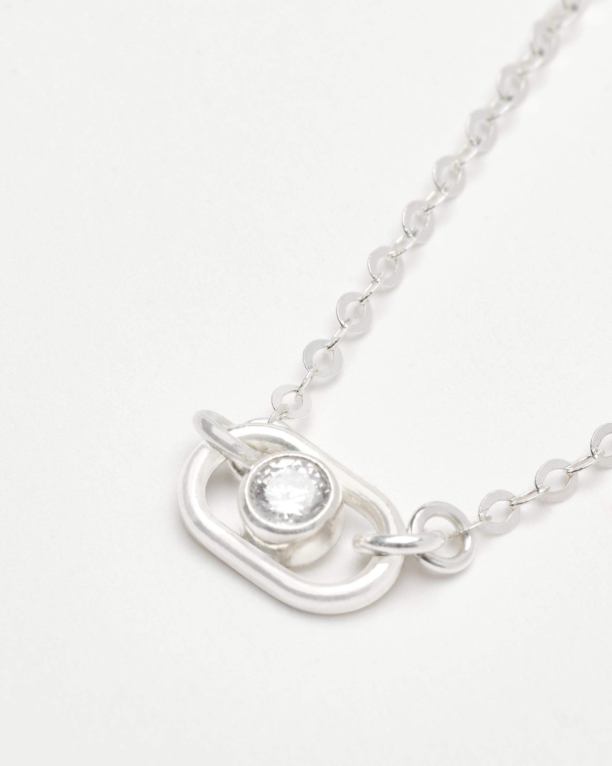 detailed look at a lab grown diamond set in sterling silver with a dainty silver chain necklace