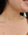 women wearing a dainty silver chain necklace with oval silver beads