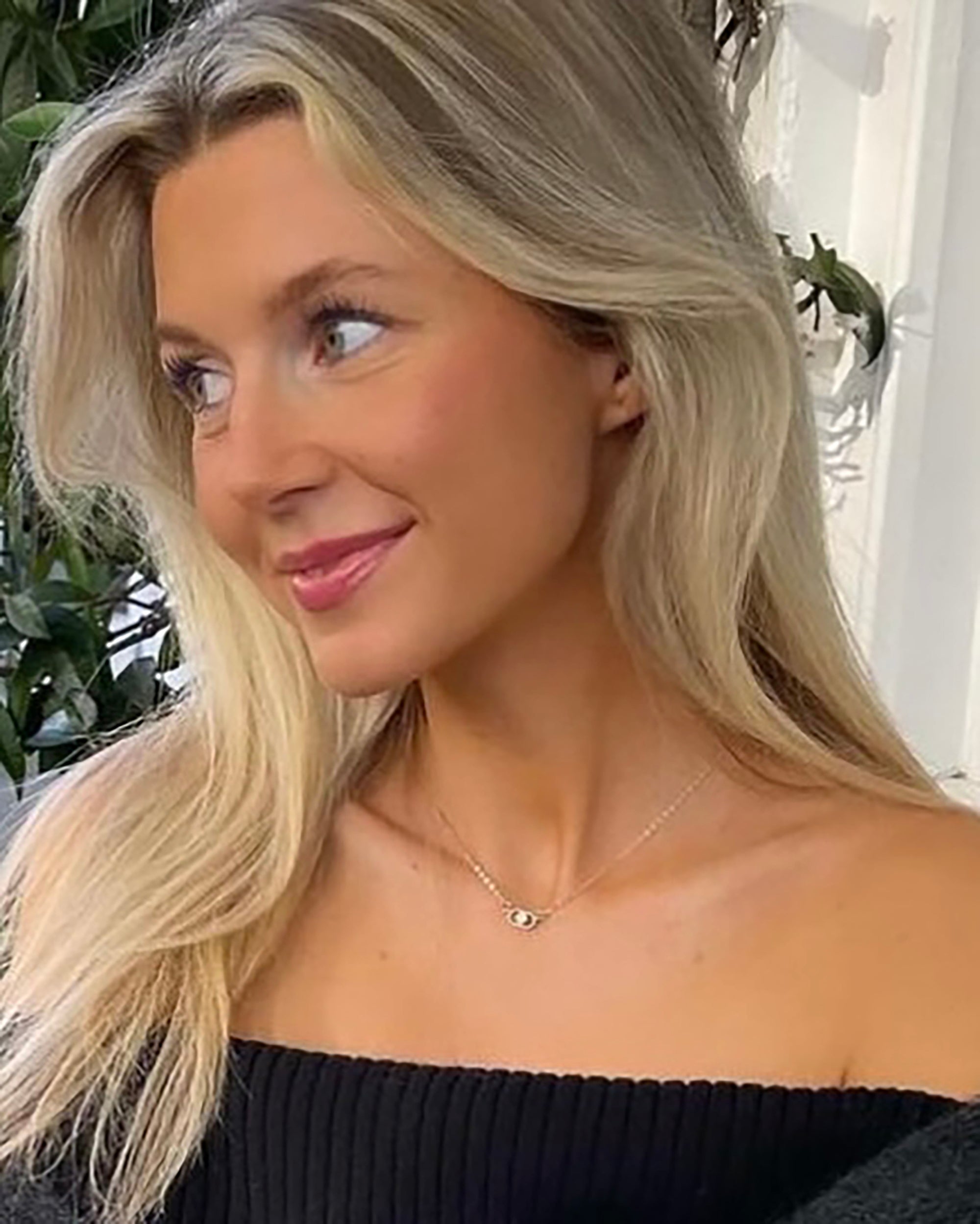 scandinavian women wearing a dainty diamond necklace in sterling silver