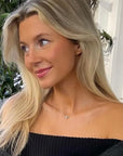 scandinavian women wearing a dainty diamond necklace in sterling silver