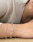 Women wearing a bracelet stack three sterling silver chains