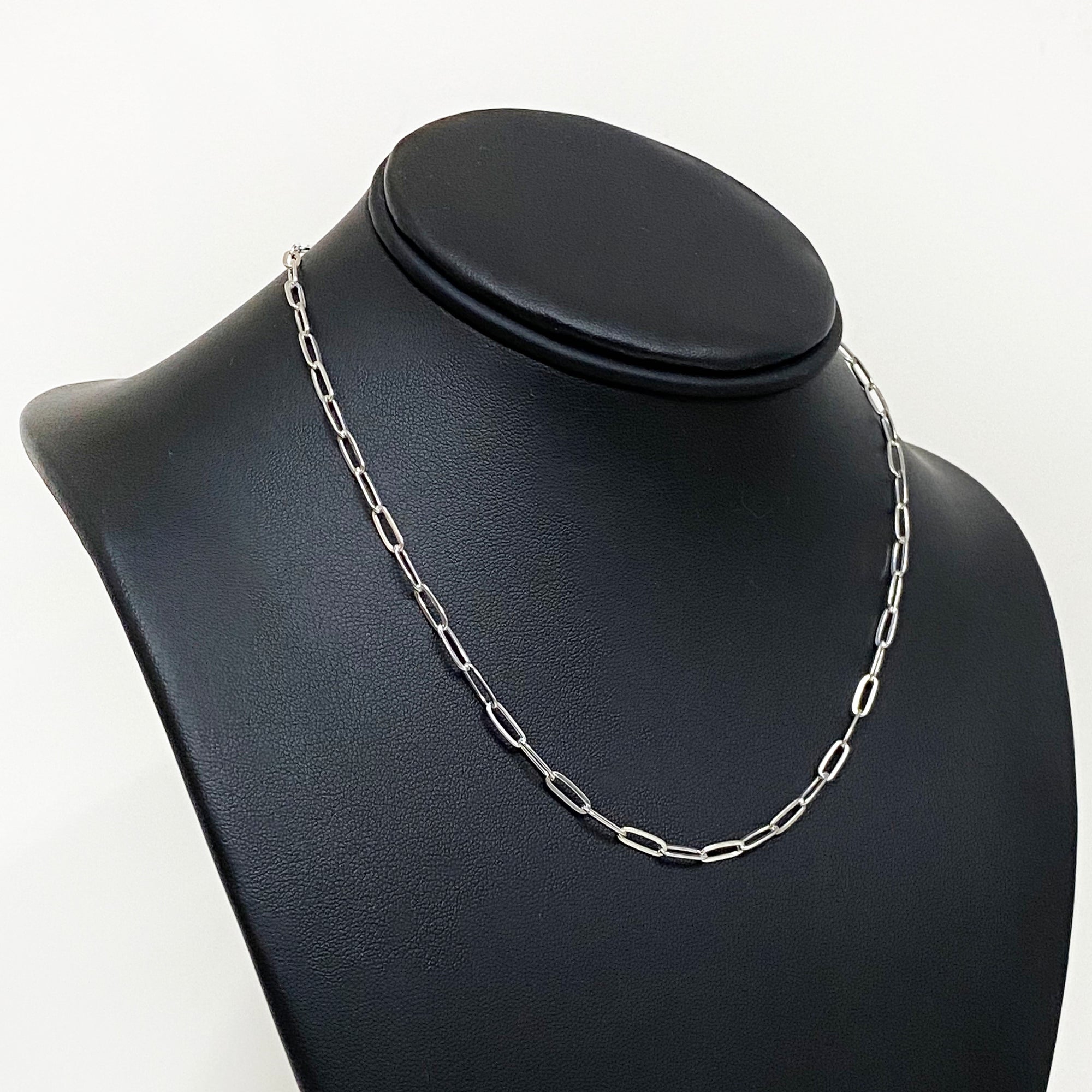 sterling silver paperclip cable chain draped on black model