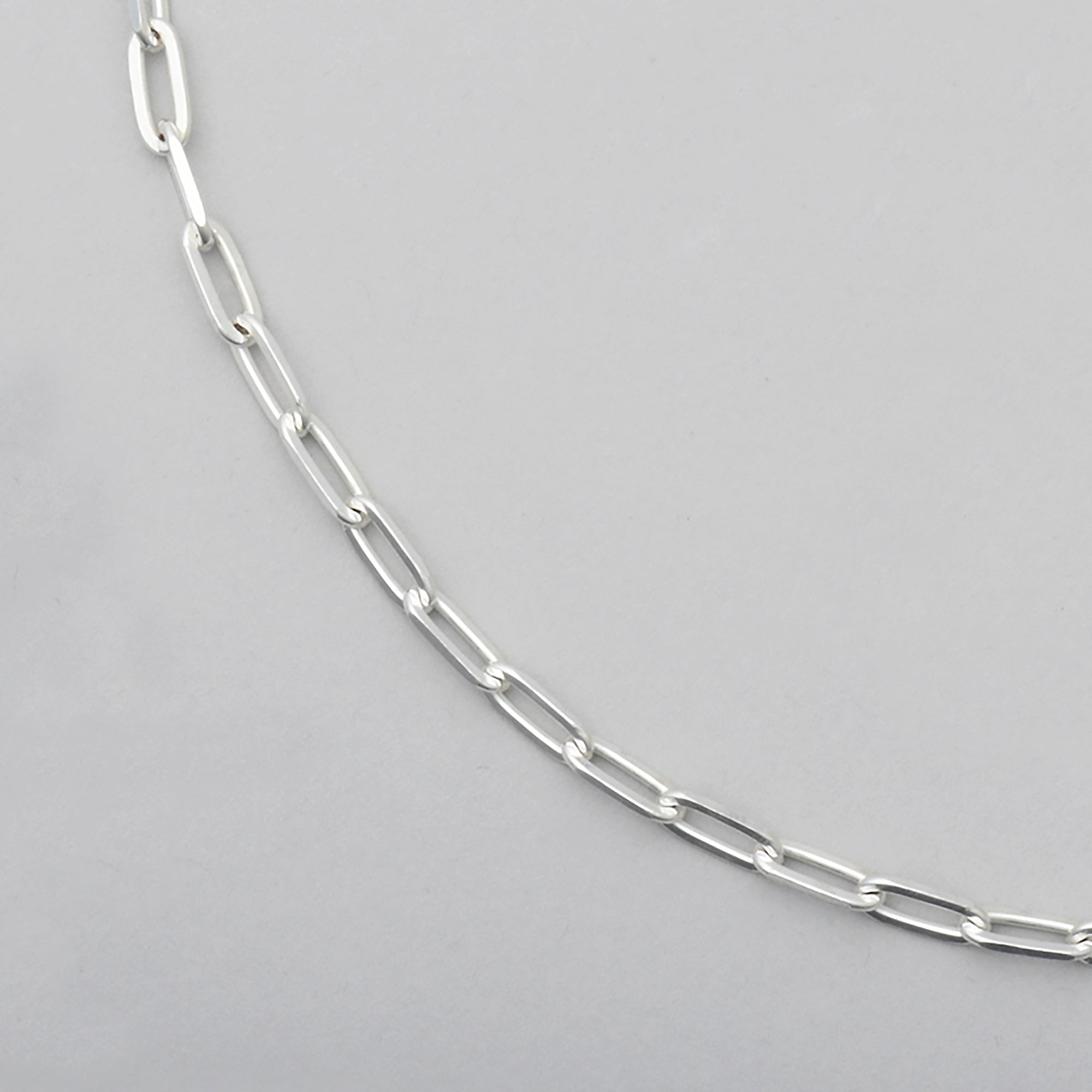 close up of sterling silver chain with diamond cut paperclip links