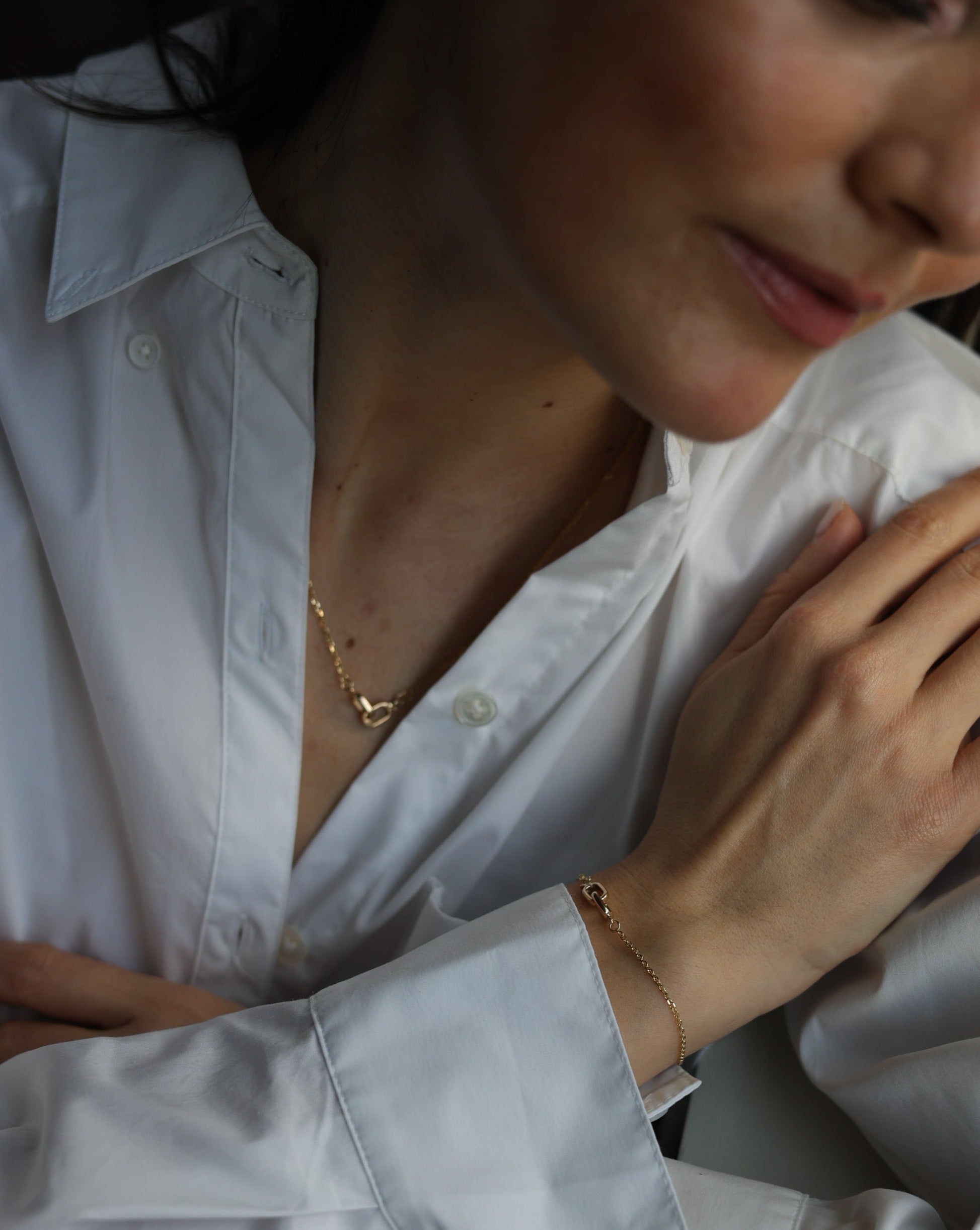 women wearing a matching necklace and bracelet set in 14 karat gold