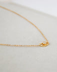 14k gold minimalist necklace featuring a lab-grown sustainable diamond, photographed in a soft neutral setting by Sincerely Chain Co.