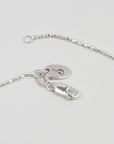 detail of sterling silver beaded necklace with sincerely chain co logo tag