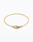 elegant 14 karat gold bracelet featuring a bevel cut cable chain and interlocking double oval clasp