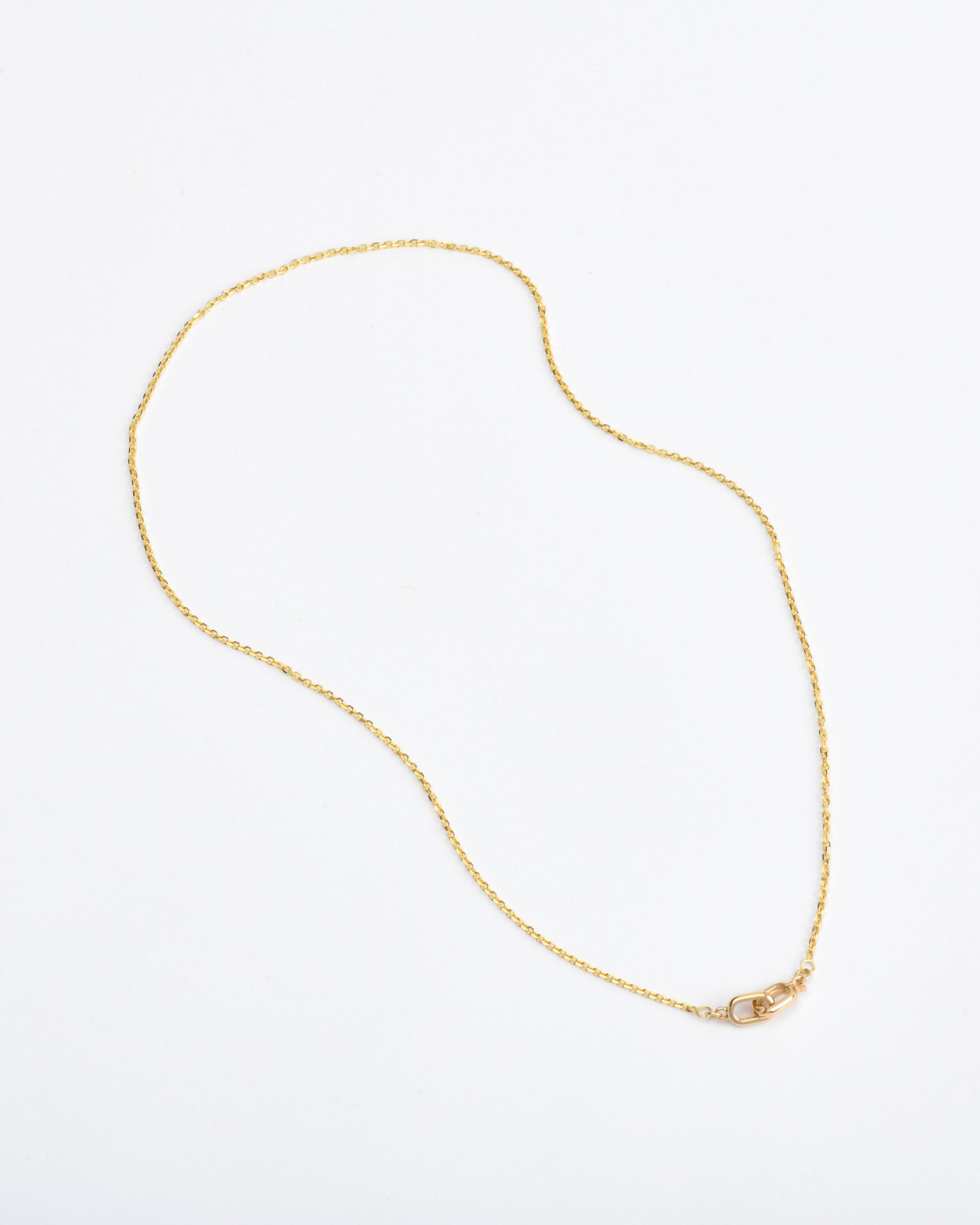 dainty 14k gold chain necklace on white background 