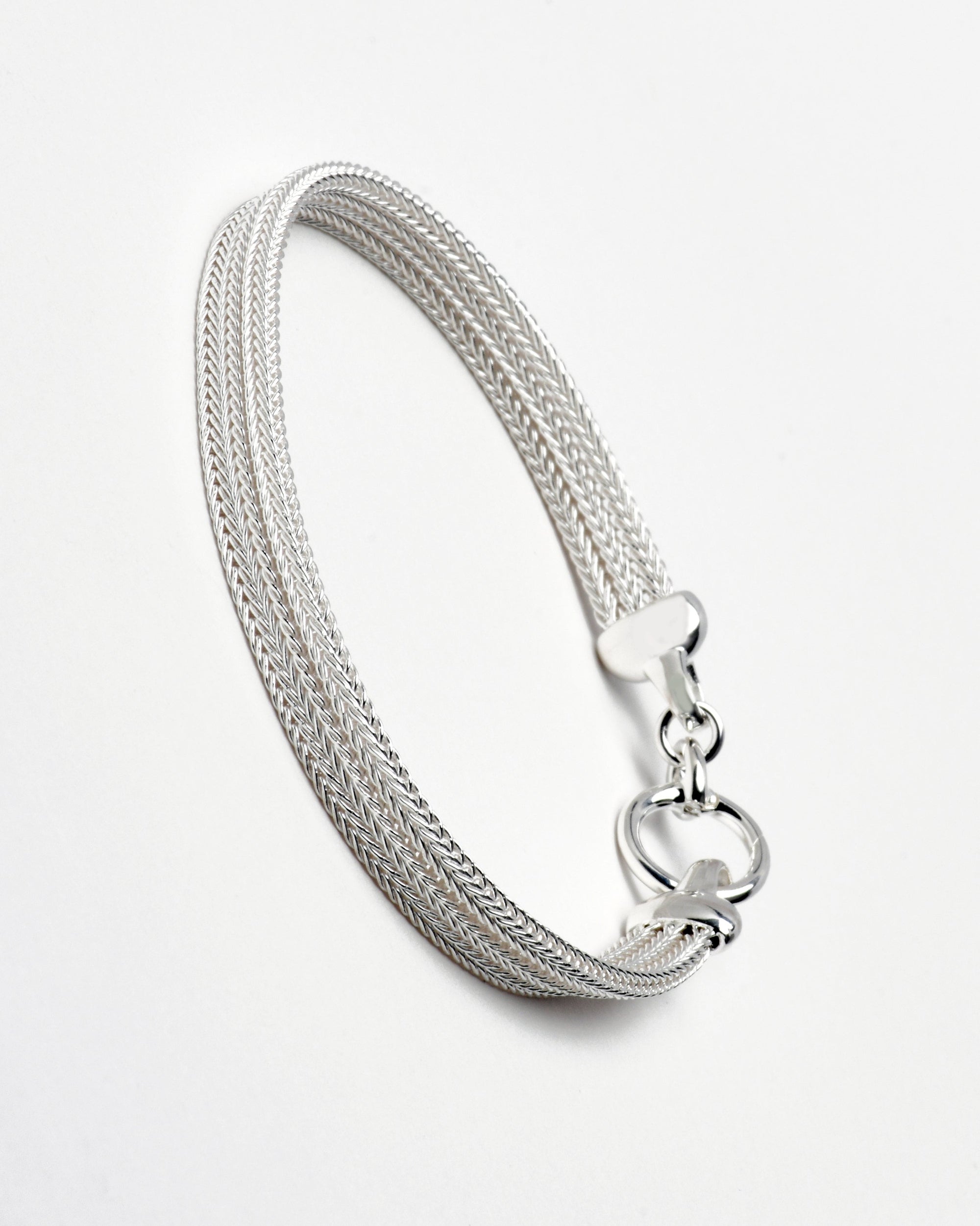 Sterling silver bracelet with a mesh style chain featuring a circular hinge clasp, by Sincerely Chain Co.