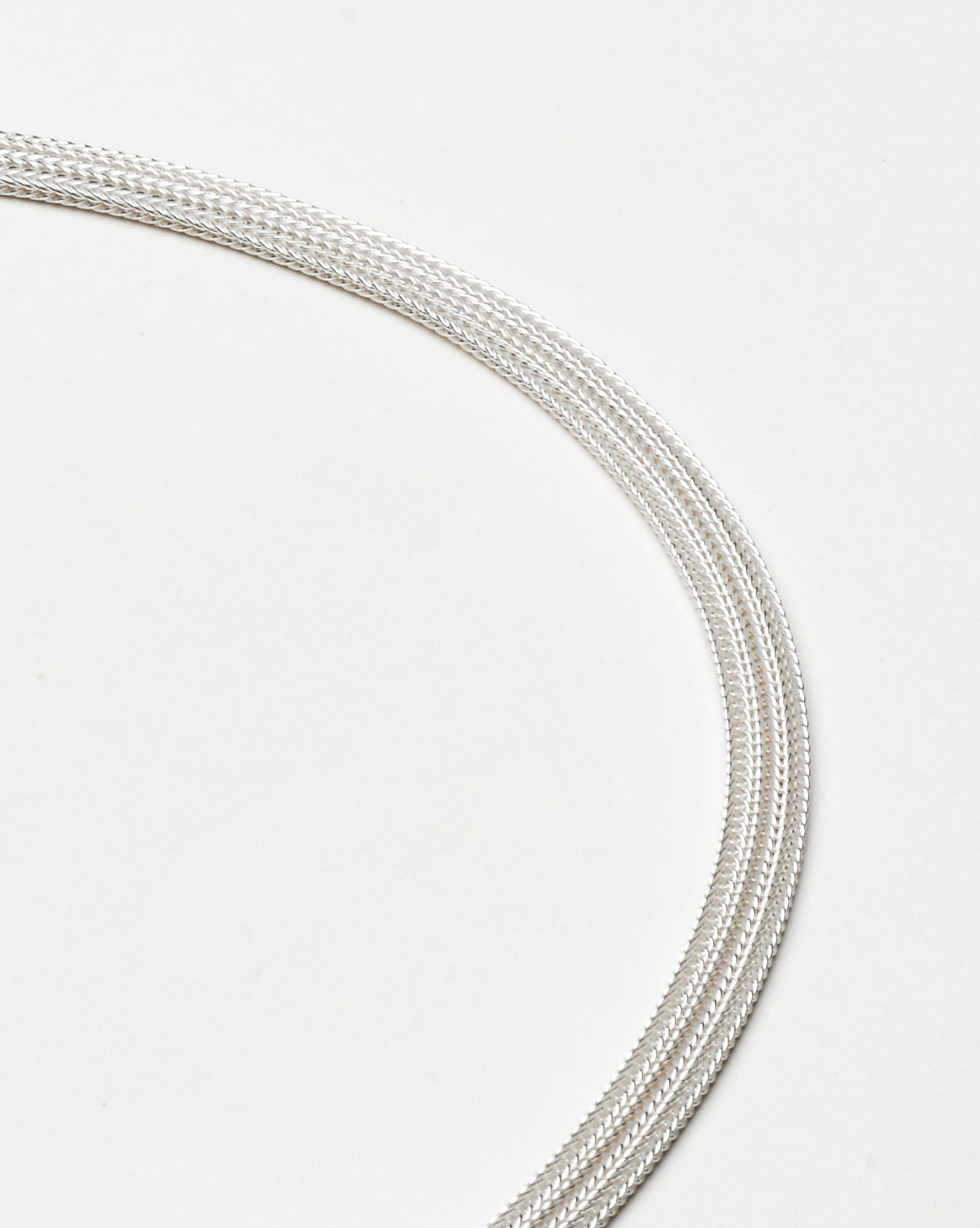 Sterling silver bracelet with a mesh style chain featuring a circular hinge clasp, by Sincerely Chain Co.