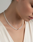 Sterling Silver mesh necklace with a centerpiece clasp worn by a women in a silk blouse.