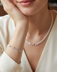 Women wearing a matching set necklace and bracelet in a fine mesh sterling silver with a featured circle hinge clasp.
