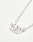 detailed look at a lab grown diamond set in sterling silver with a dainty silver chain necklace
