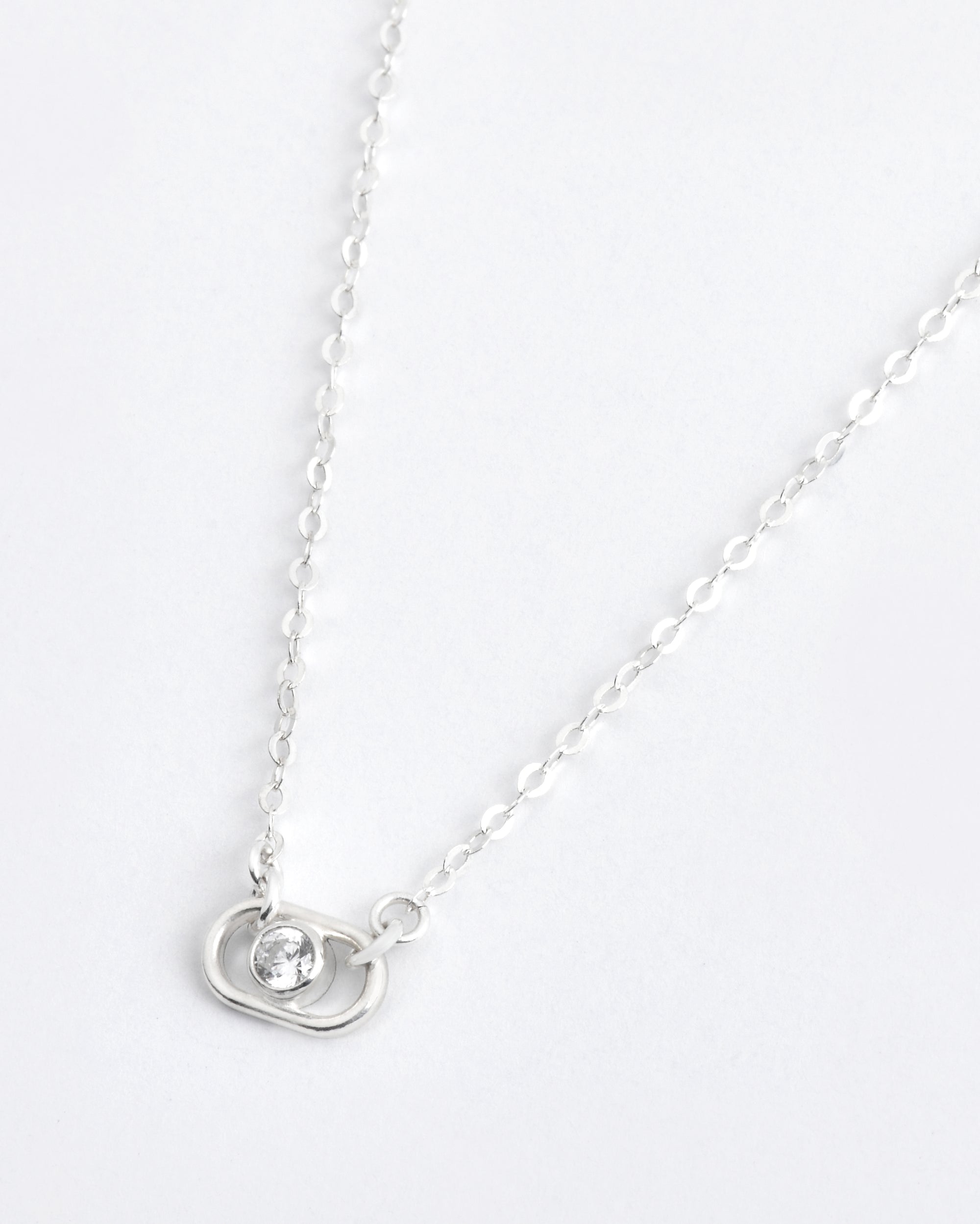 sterling silver necklace with a round diamond charm pendant