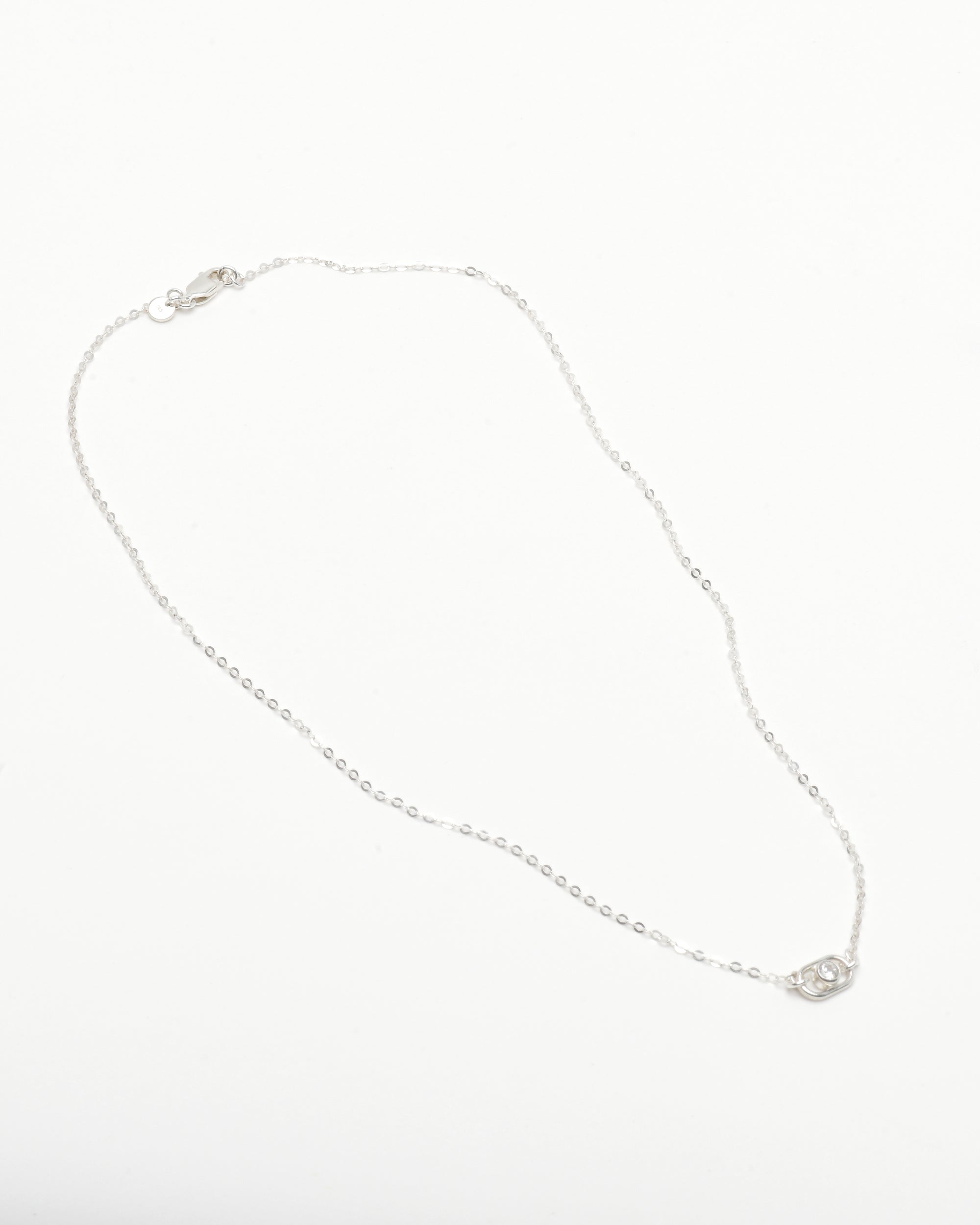 silver necklace with dainty round diamond pendant 