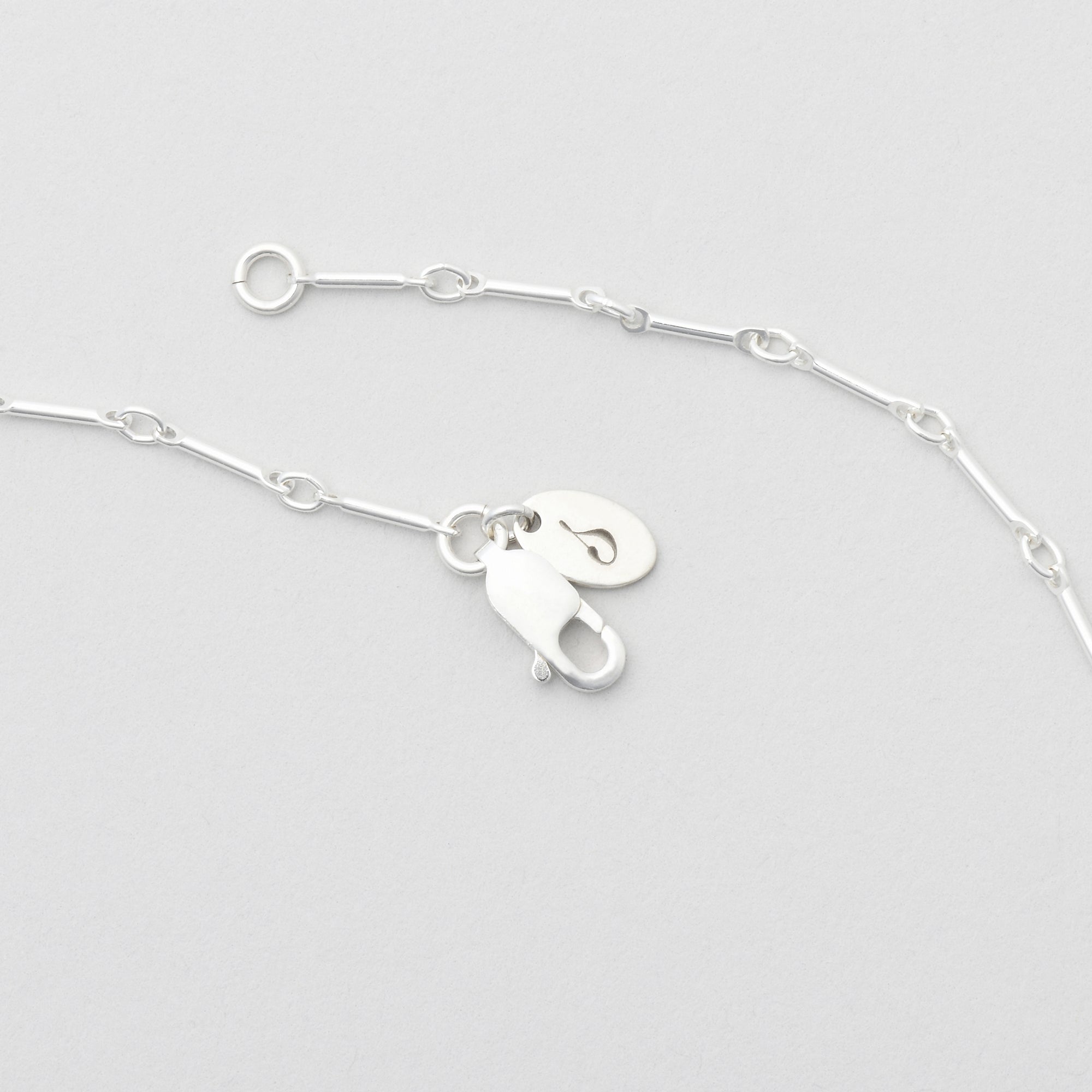 Bar and ring chain in sterling silver with branded logo tag by Sincerely Chain Co.