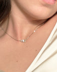 women wearing a diamond charm necklace with a cable chain in sterling silver