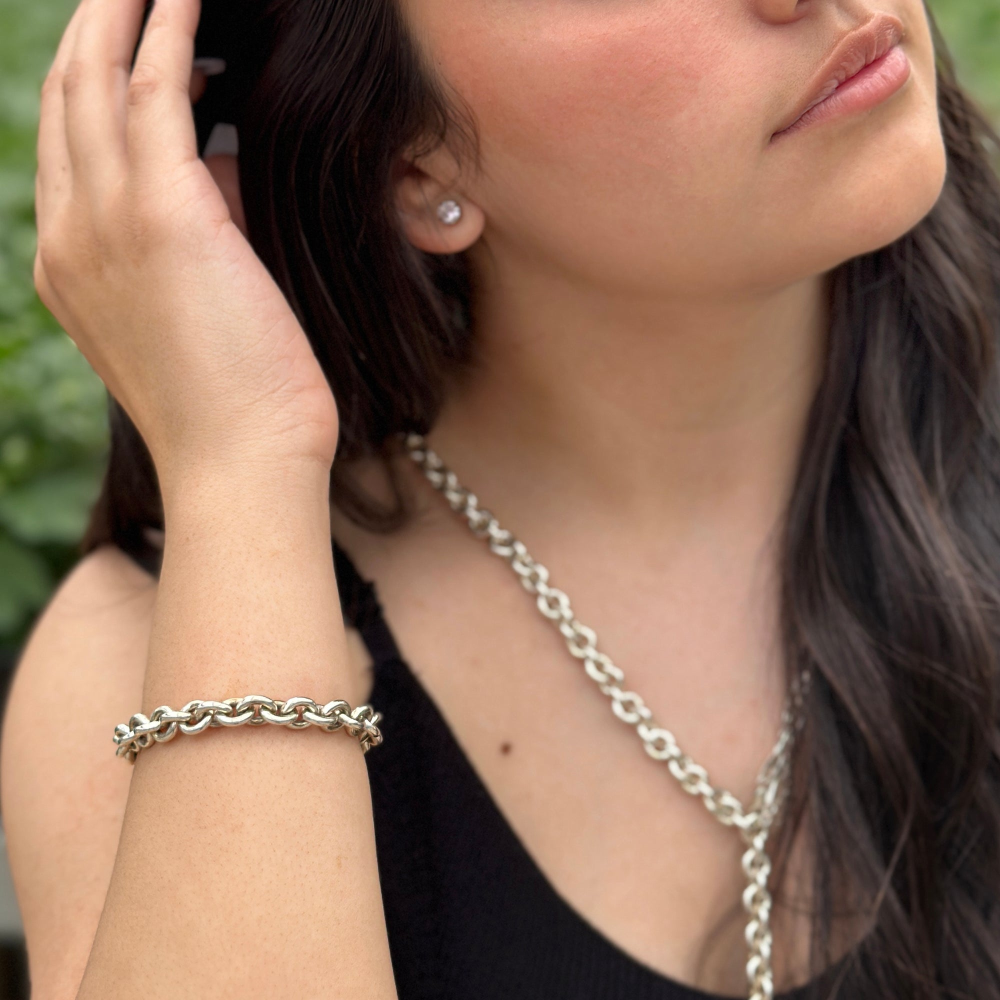 big silver chain bracelet with matching necklace on female model