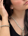 big silver chain bracelet with matching necklace on female model