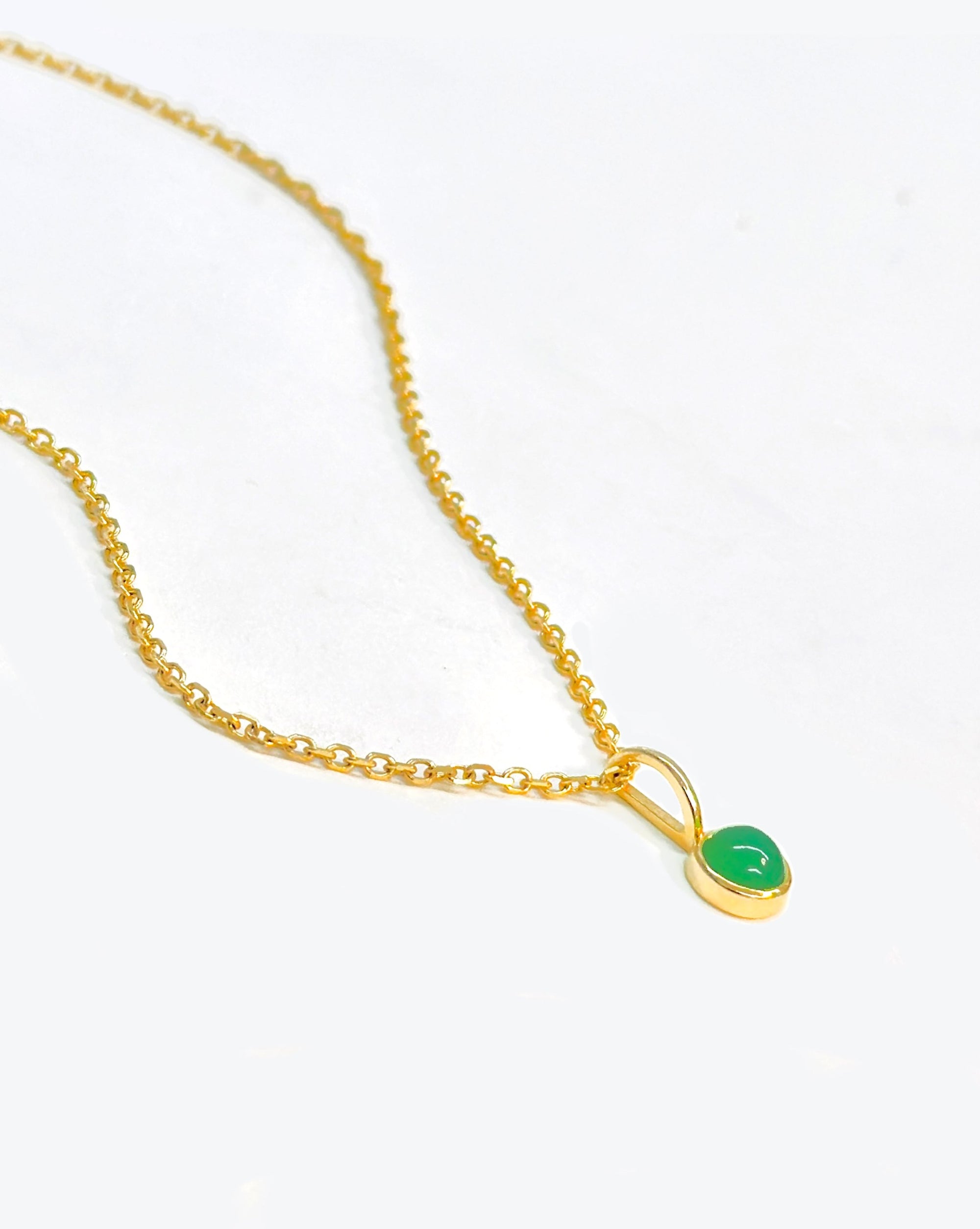 bright 14k gold chain necklace featuring a radiant green gemstone set in gold