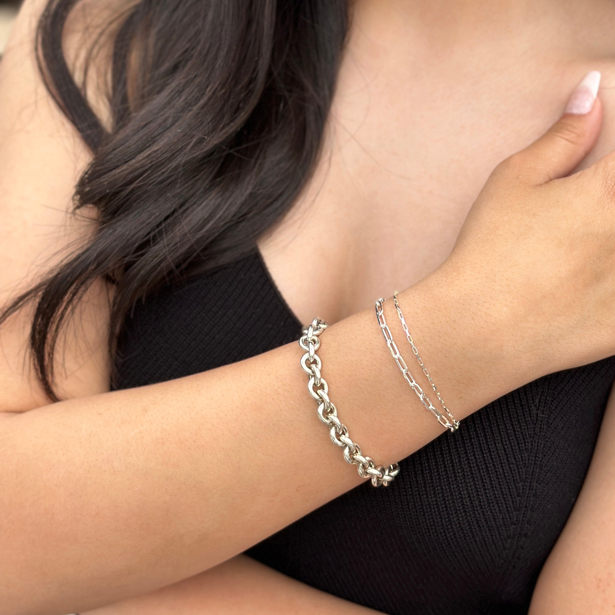 women with tan skin wearing bright silver bracelets
