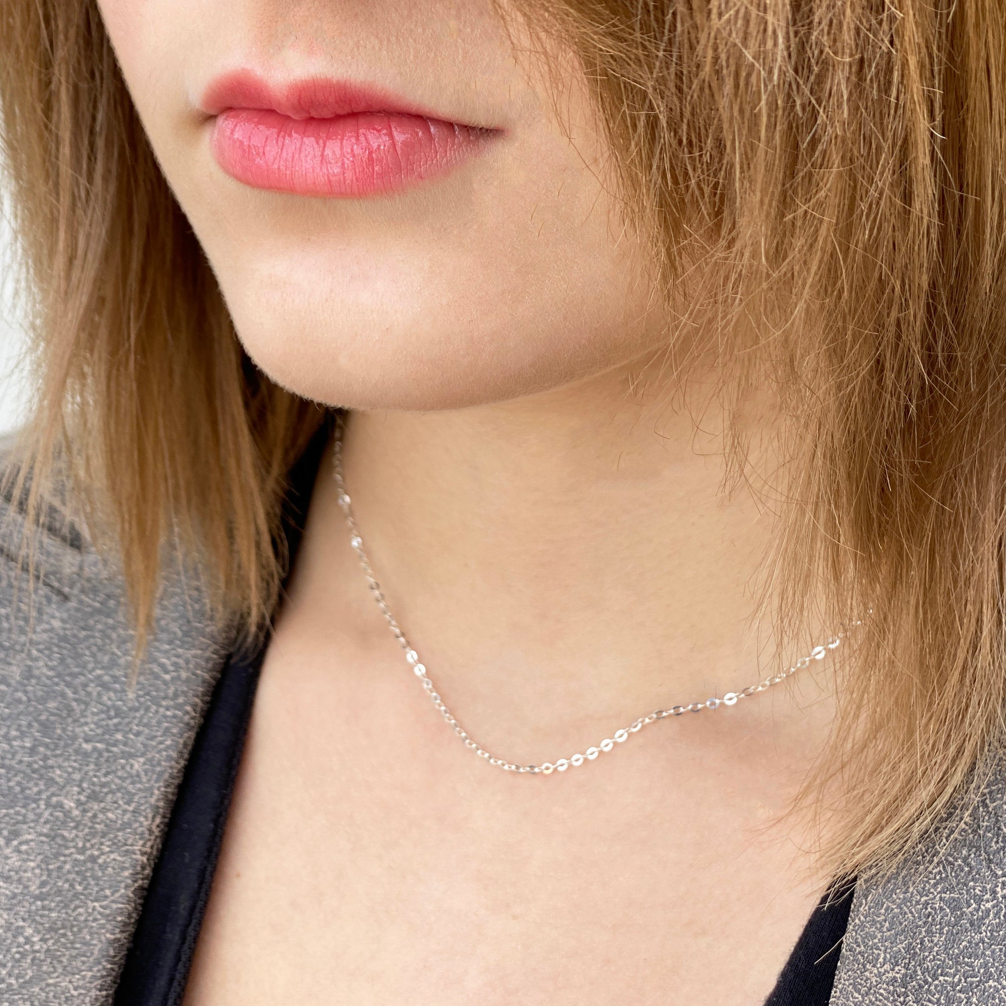 professional women wearing a delicate sterling silver cable chain necklace