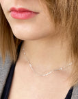 professional women wearing a delicate sterling silver cable chain necklace