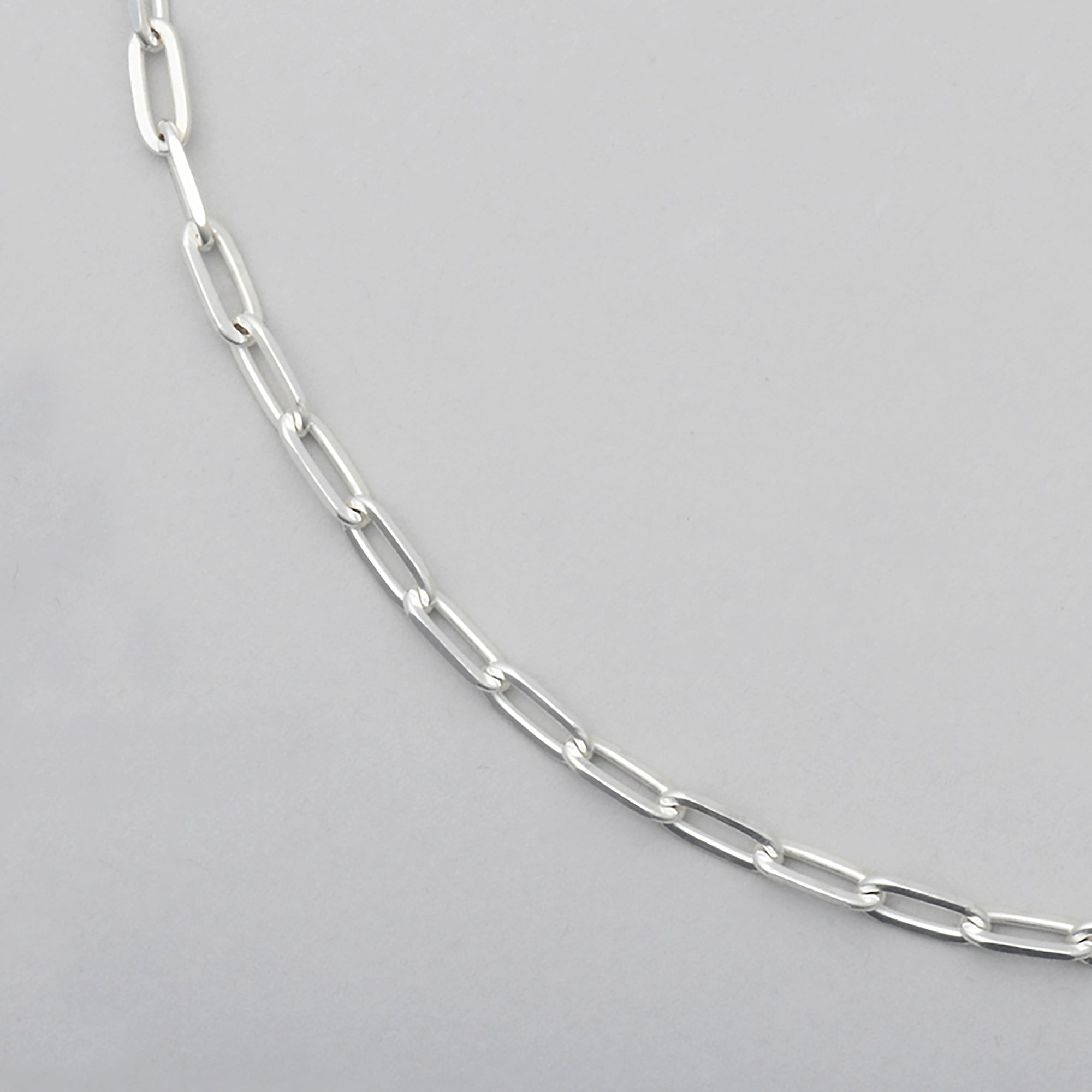 close up of sterling silver chain with diamond cut  paperclip links